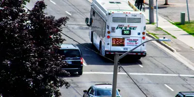 aerial view of bus driving away on street