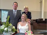 Couple seated with wedding officiant