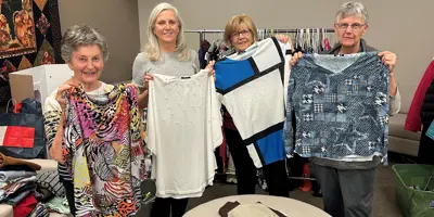 Volunteers setting up a clothing sale