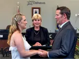 Couple standing before wedding officiant