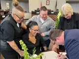 Couple and witnesses signing marriage record