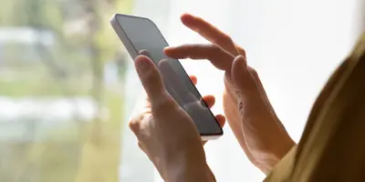 person on a phone submitting a concern