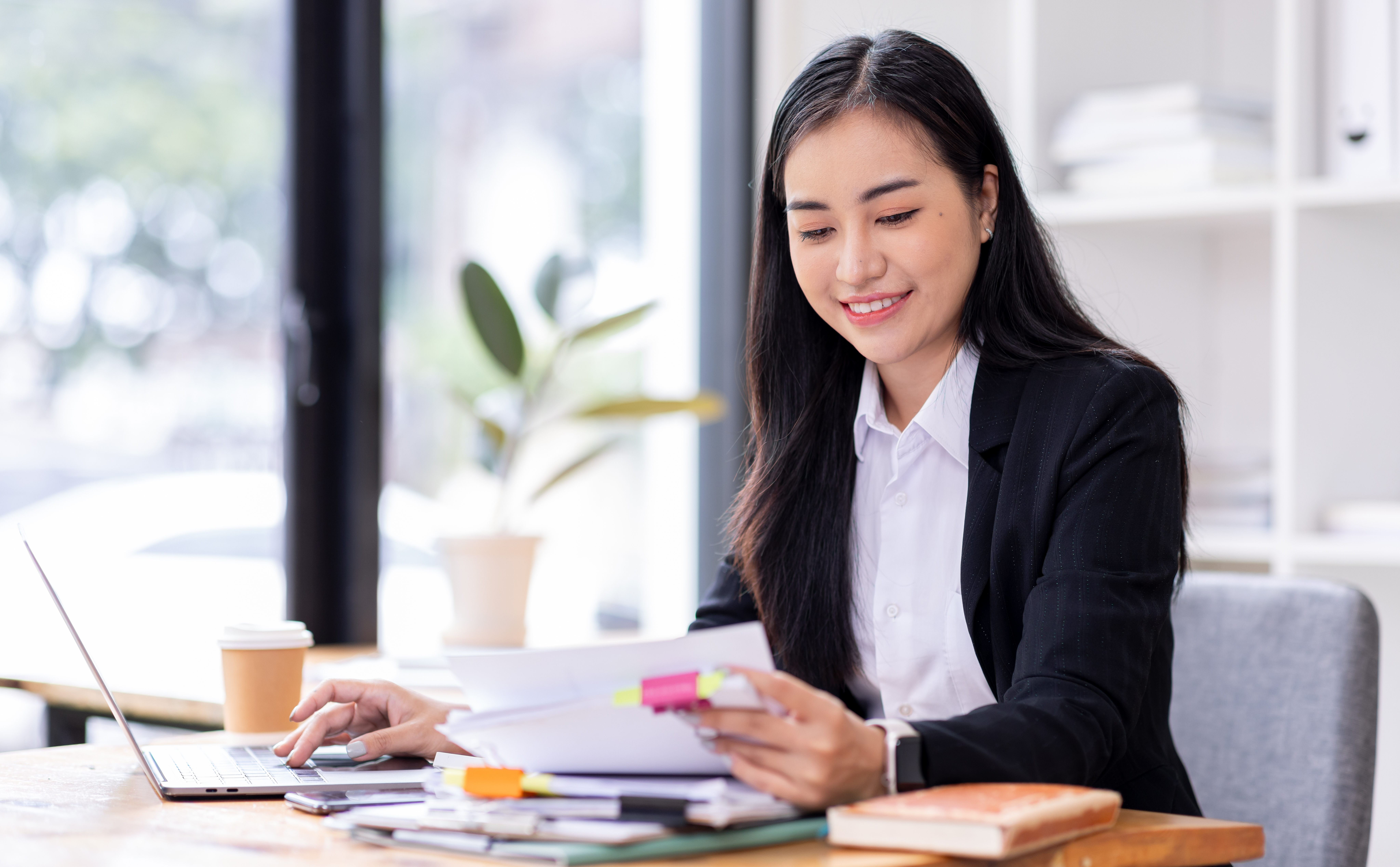 Woman Reviewing Documents At Computer