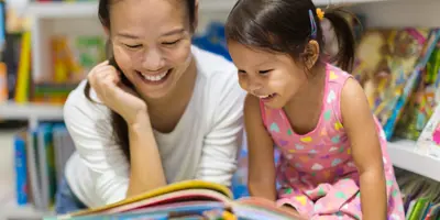 Mother And Daughter reading a book