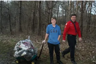 youth and adult with wagon of garbage